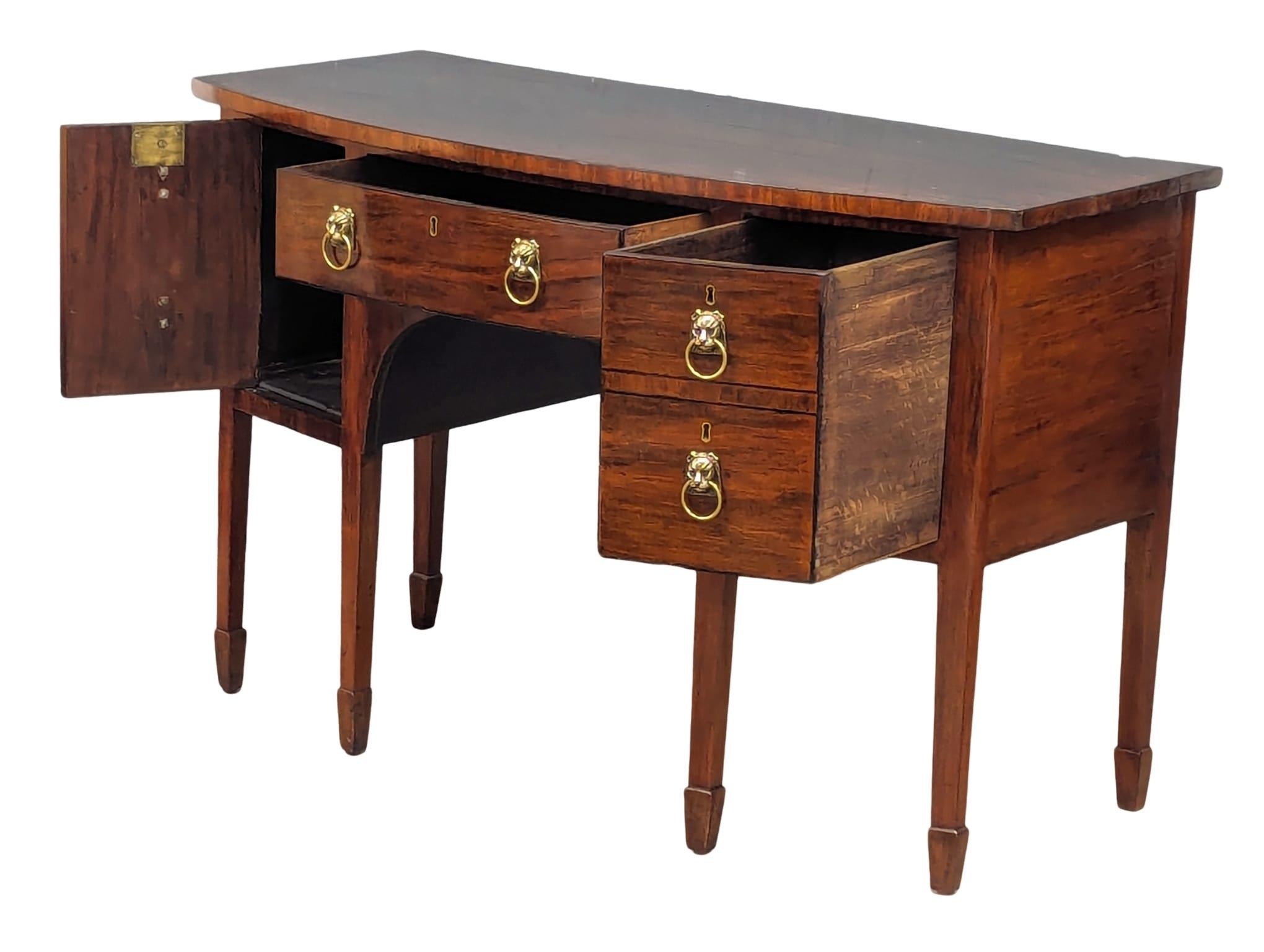 A 19th Century mahogany bow front side table with brass lion mask handles. By Spillman & Co. London. - Image 7 of 7