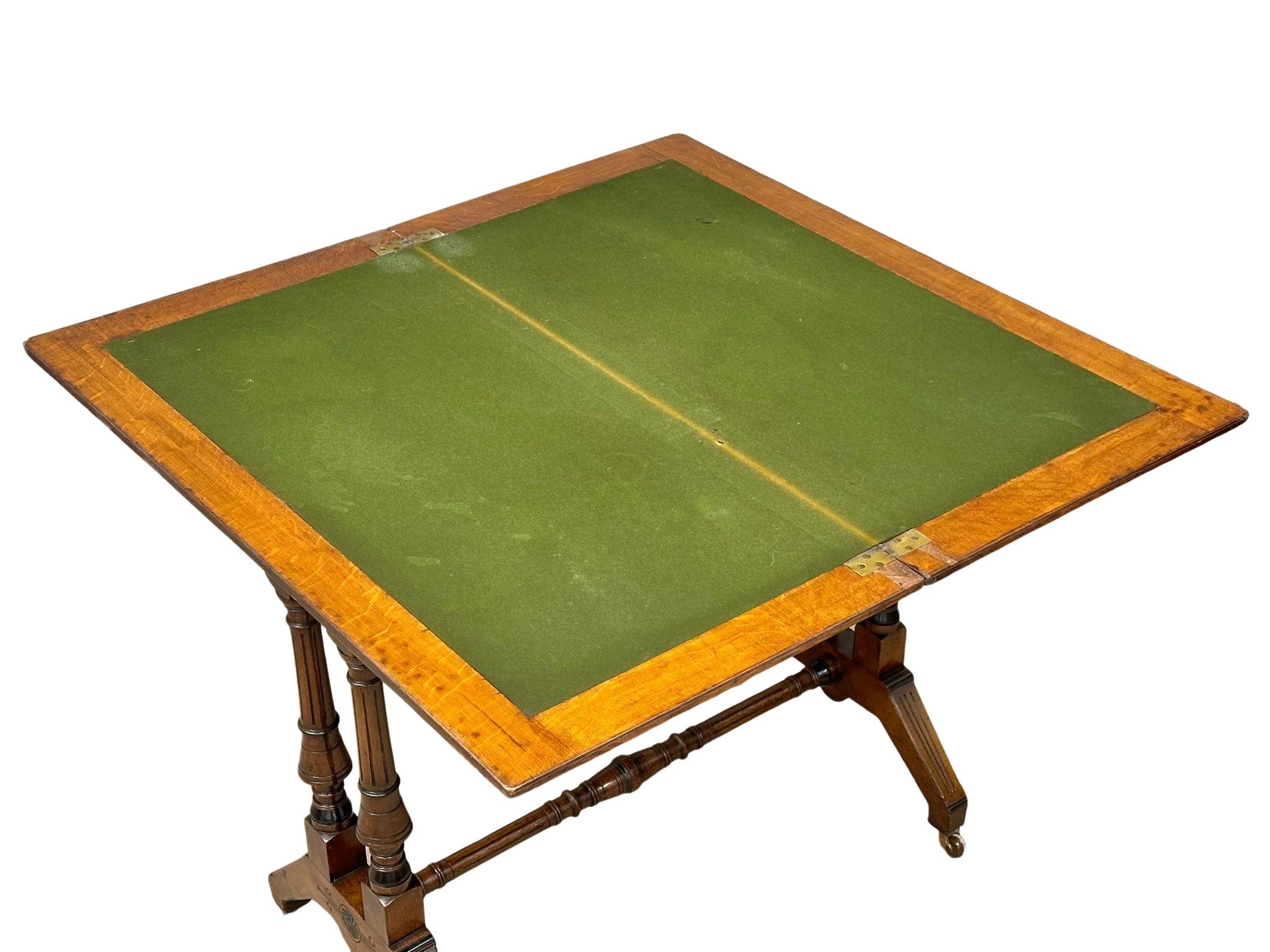 A Late Victorian oak turnover games table. 91x46x74cm - Image 3 of 5