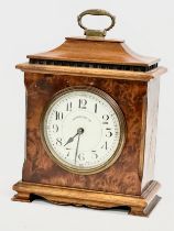 An Early 20th Century Walker & Hall burr walnut mantle clock. French works. 16x8x21cm