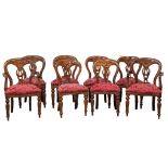 A set of 8 Victorian style mahogany balloon back dining chairs on reeded legs.