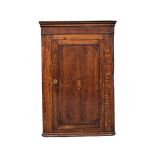 A George III inlaid oak wall hanging corner cabinet with fitted shelves. Circa 1790-1800. 69.5x38.