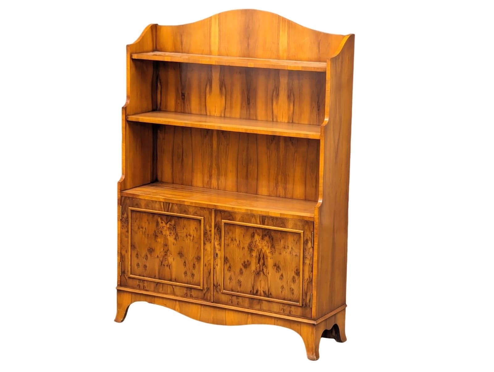 A yew wood open bookcase with 2 door cupboard. 84x26x120cm