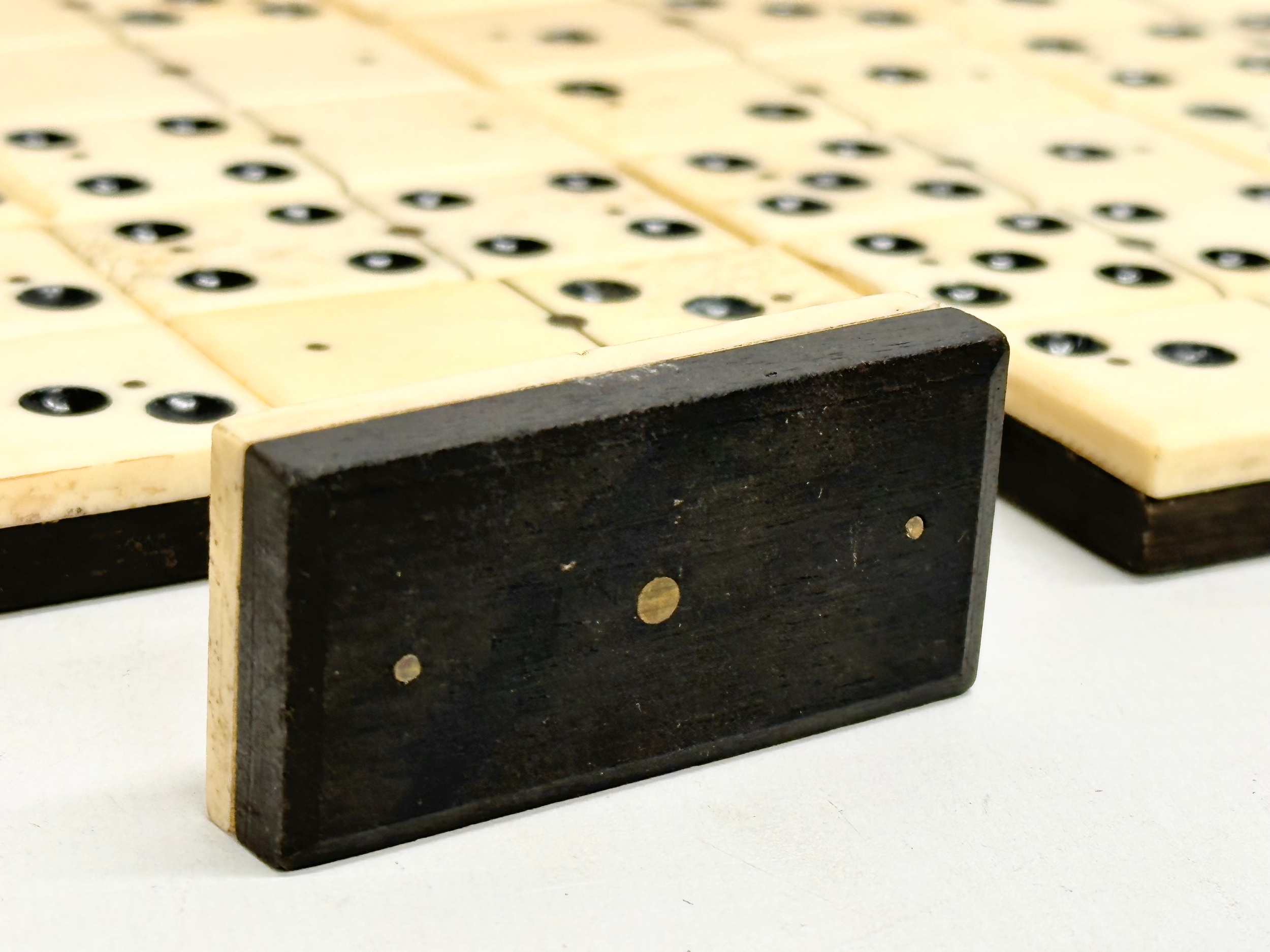 A collection of 19th Century bone and ebony dominoes with wooden box. Pieces 5.5cm. Box 21cm. - Image 5 of 6