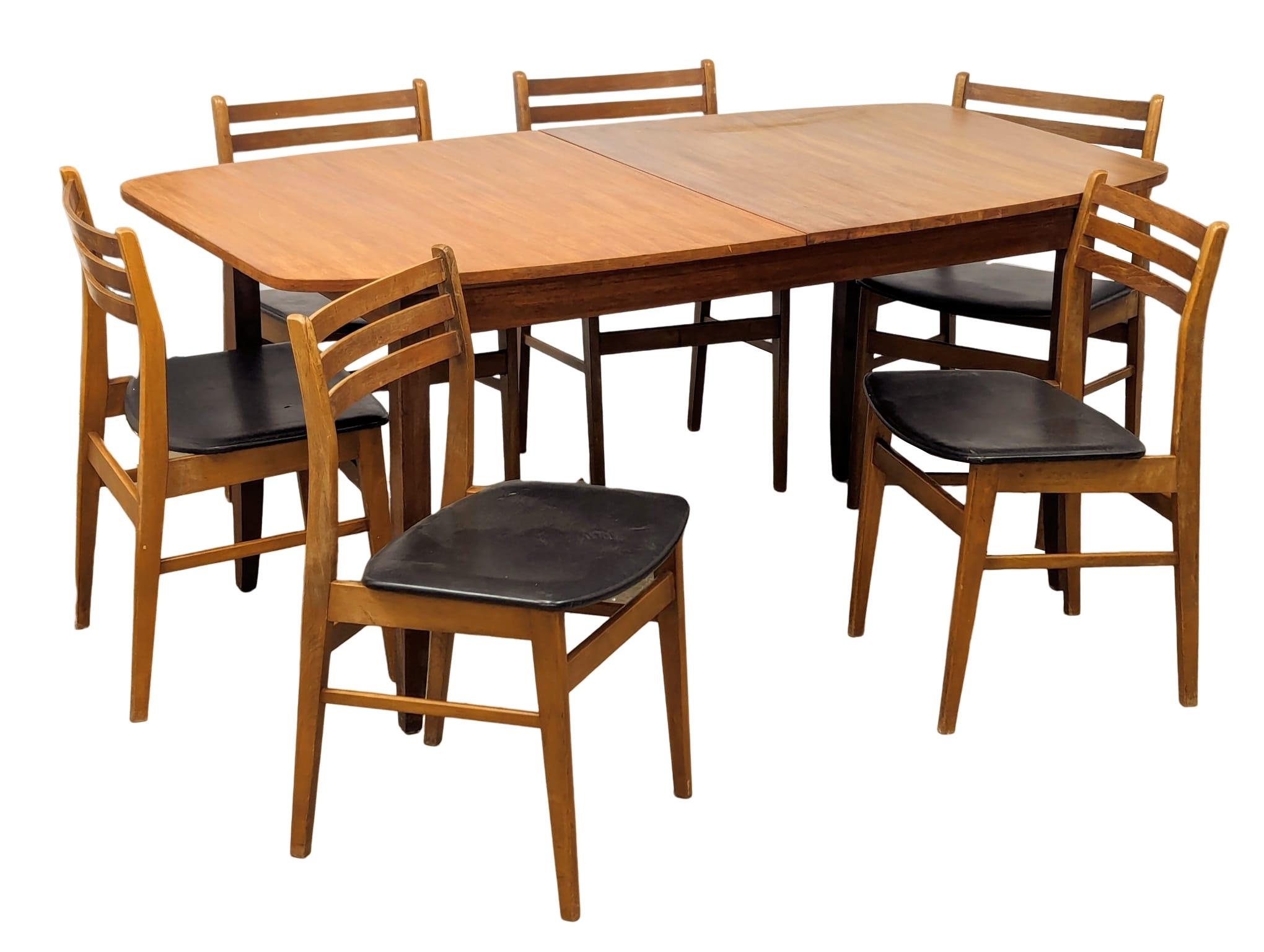 A mid century teak table and 6 chairs, 168cm x 89cm x 75cm. Extended 211cm x 89cm x 75cm
