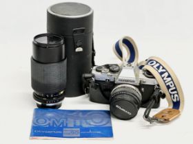 An Olympus OM 10 camera with a Tokina lens.