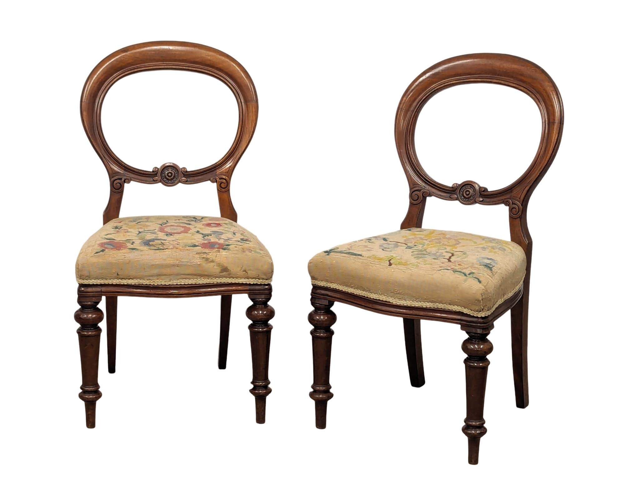 A pair of Victorian mahogany balloon back chairs.