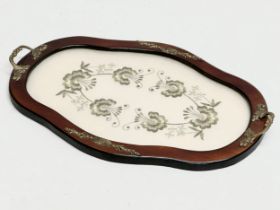 A vintage mahogany framed tray with brass mounts and embroidered panel. 45x30cm