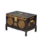 A Japanese lacquered brass bound trunk on stand with hand painted bird and flower motif. 73.