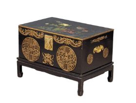 A Japanese lacquered brass bound trunk on stand with hand painted bird and flower motif. 73.