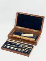A Late 19th Century Elliot Brothers bone and brass draughtsman’s set in mahogany case. 19.5x11x4.5cm