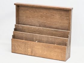 An Early 20th Century oak wall mounted paper rack. 61x14x49.5cm