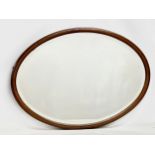 An Edwardian inlaid mahogany bevelled mirror. 89x64cm