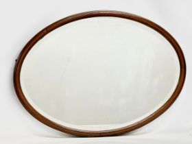 An Edwardian inlaid mahogany bevelled mirror. 89x64cm