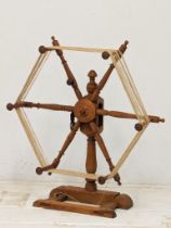 An Early 20th Century skein winder and a floor standing distaff. 69x79cm