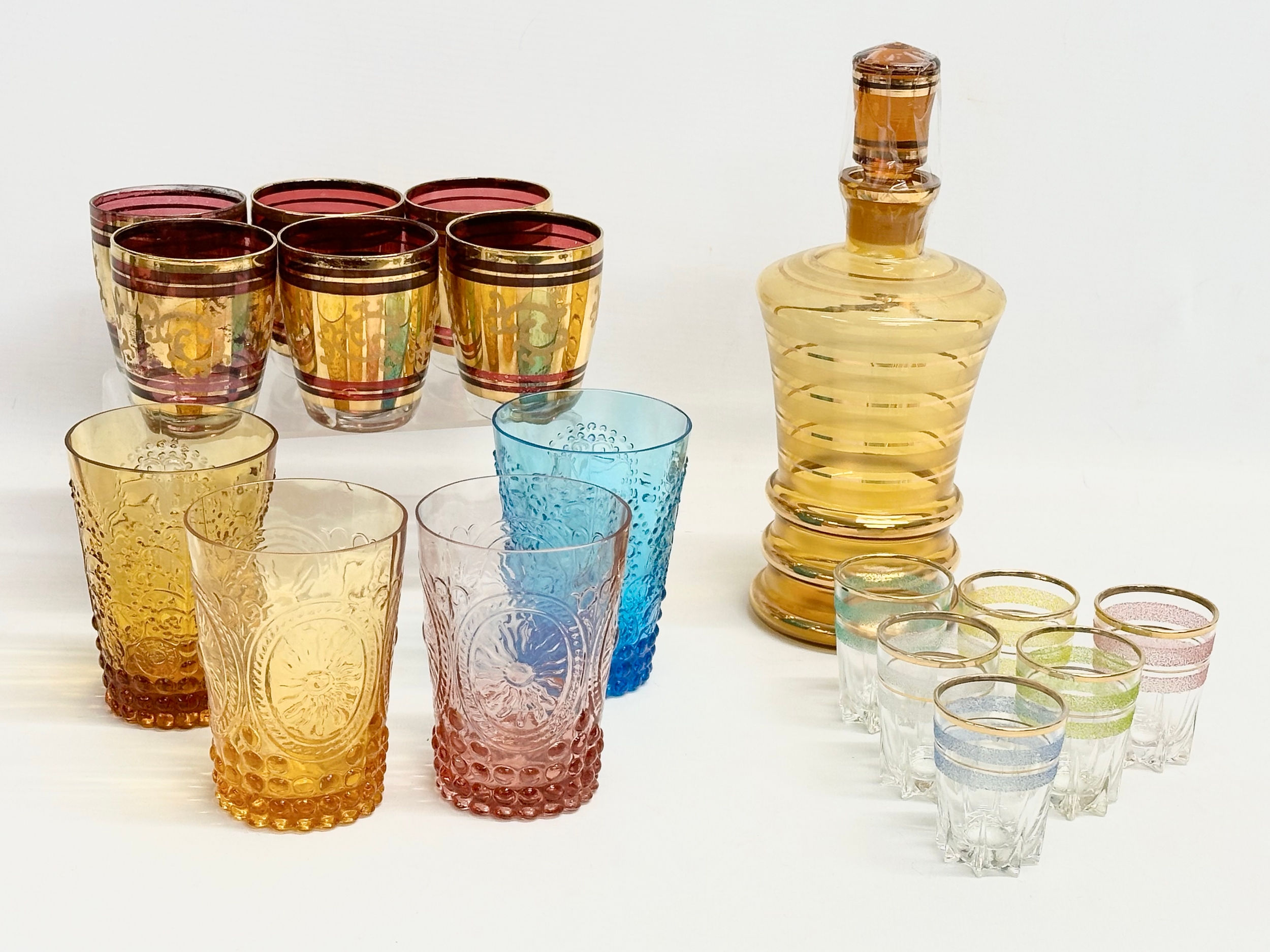 A collection of Mid 20th Century coloured drinking glasses and decanter.