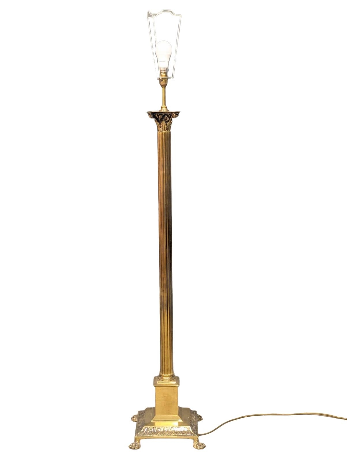 A brass Corinthian style standard lamp. 140cm