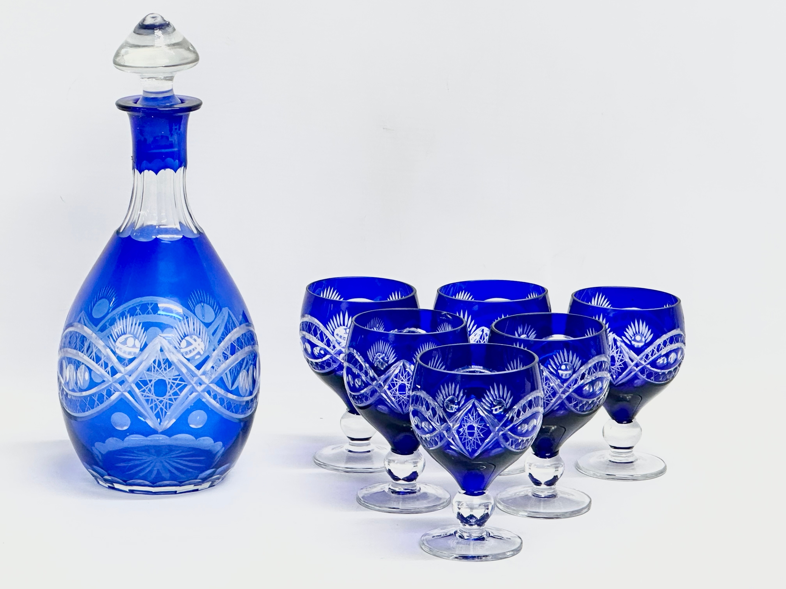 A 7 piece 20th Century Bohemian blue crystal drinks set. Glasses 11cm. Decanter 29cm.