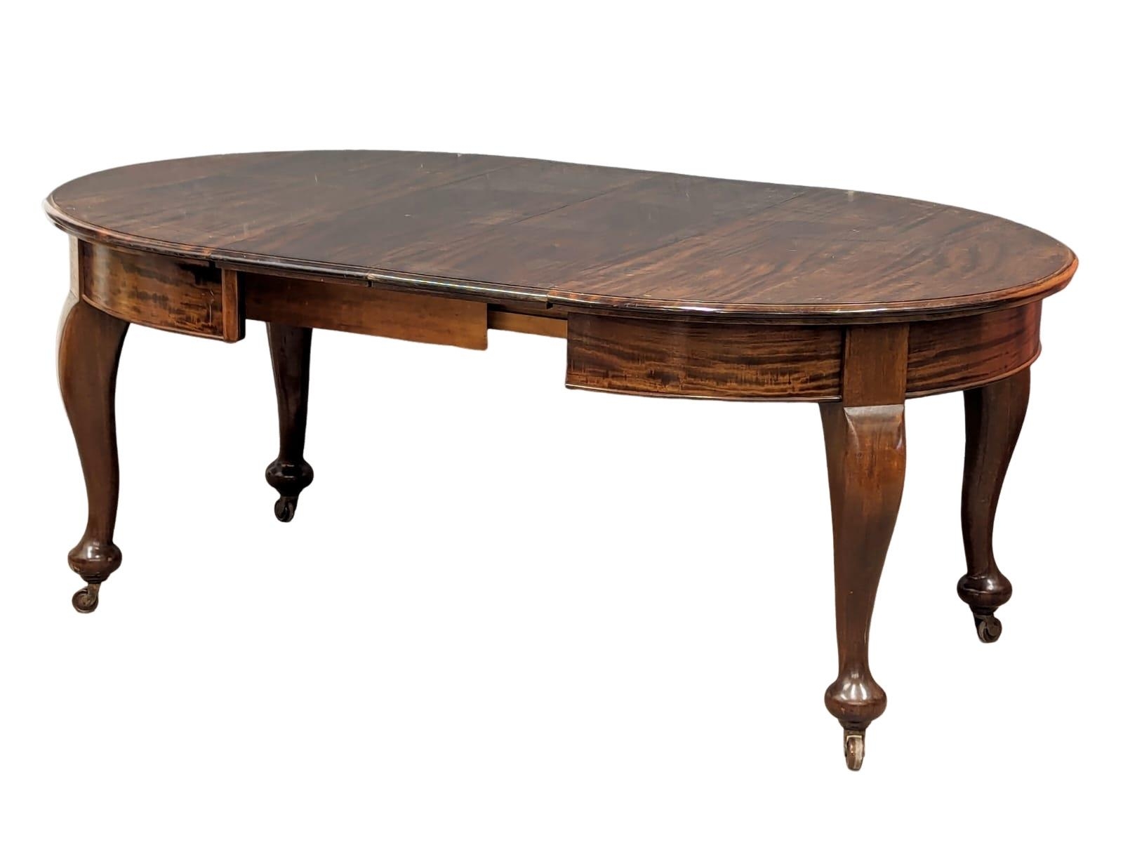 An early 20th Century mahogany telescopic dining table with 2 leaves, 185cm x 113cm x 76cm extended. - Image 7 of 7