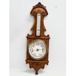 A Victorian carved oak barometer. 28x84cm W