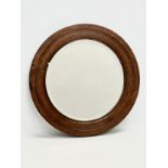 An Early 20th Century oak framed spinning wheel mirror. Circa 1900. 52.5cm