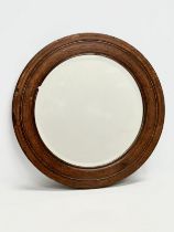 An Early 20th Century oak framed spinning wheel mirror. Circa 1900. 52.5cm