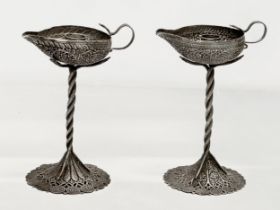 A pair of Late 19th Century candleholder oil lamps. With pierced plated bases and cobra columns.