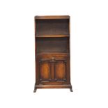 A vintage oak open bookcase with drop down paper rack. 48.5x22.5x105cm