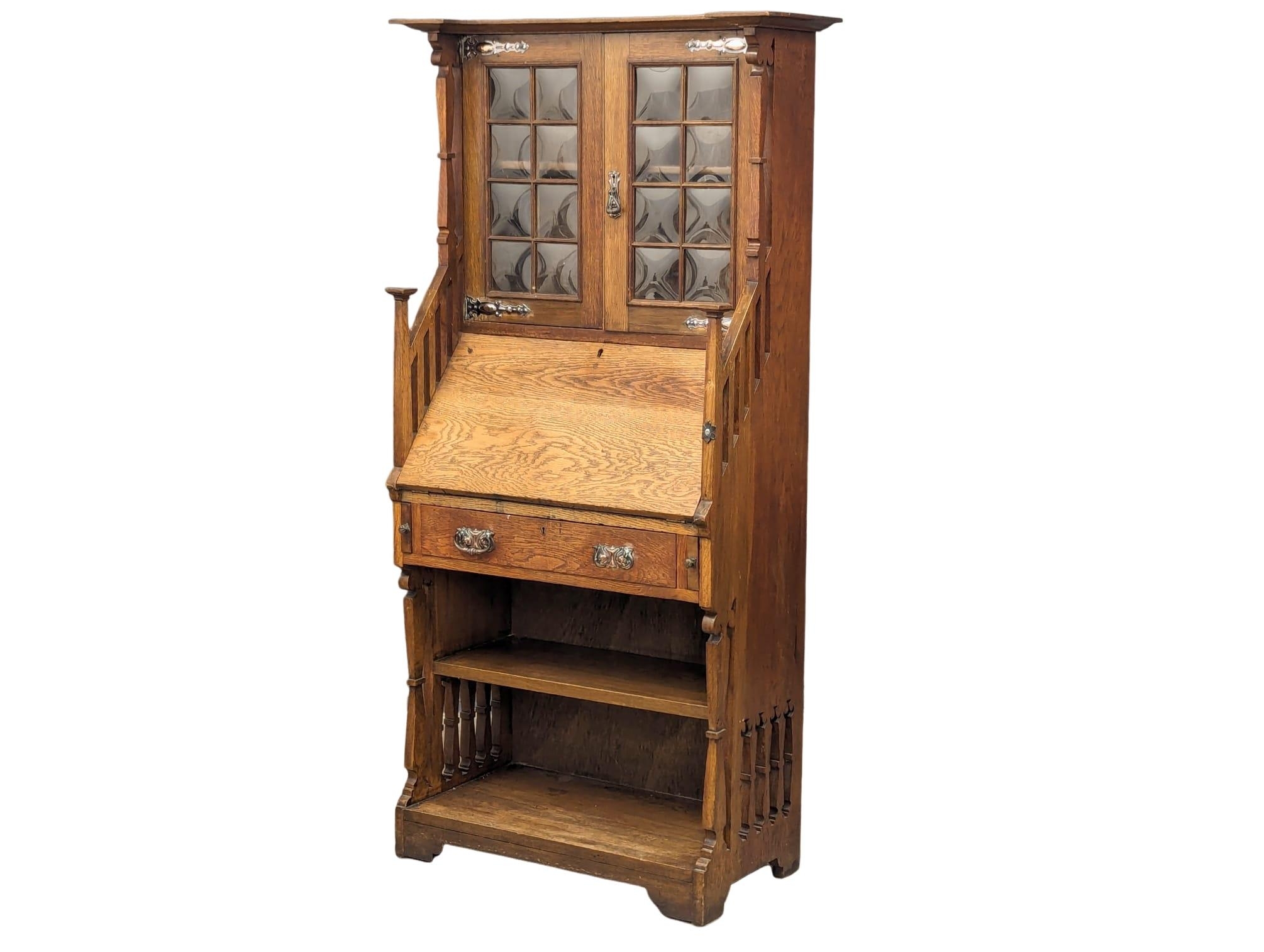 A late 19th Century oak Arts & Crafts bureau bookcase, in the manner of Liberty. Circa 1880-1890s.