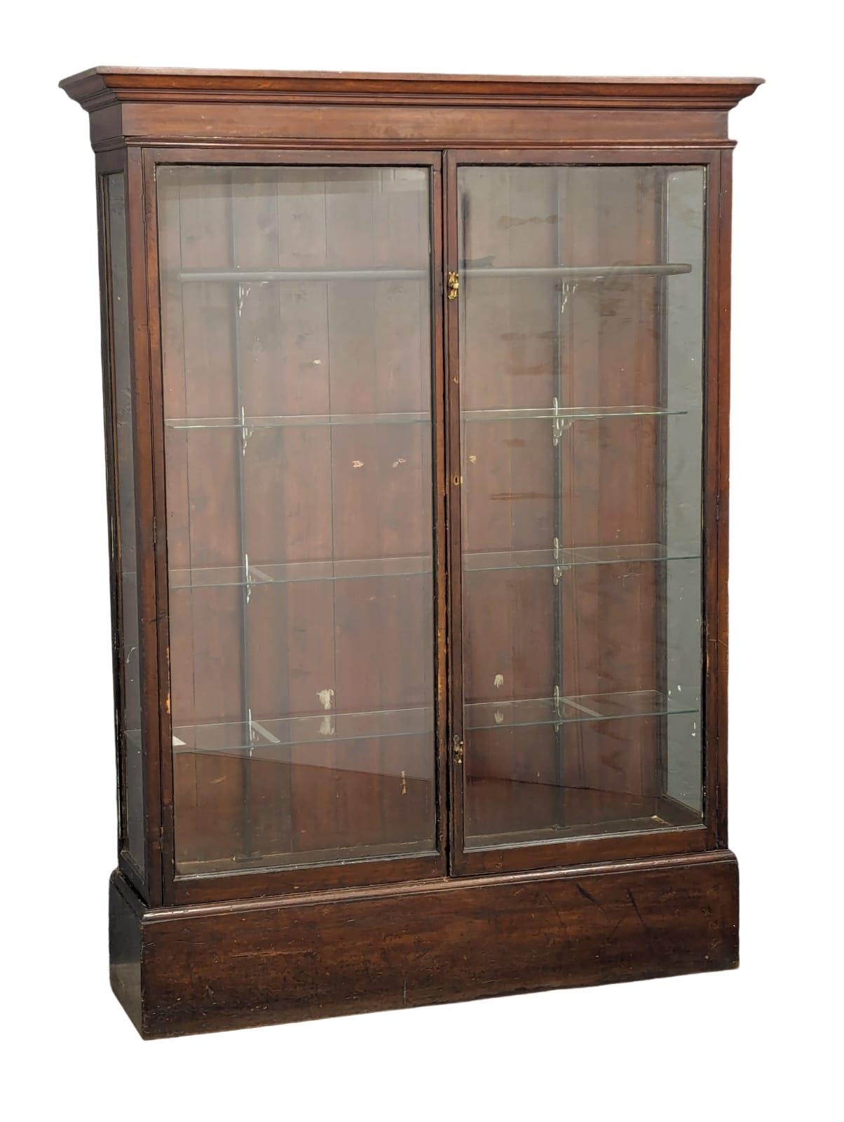 A large Late 19th Century mahogany shop display cabinet with glass shelves. Circa 1890. 157.