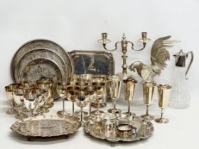 A collection of silver plate. 3 sets of chalices, salvors, silver plated rooster, claret jug etc