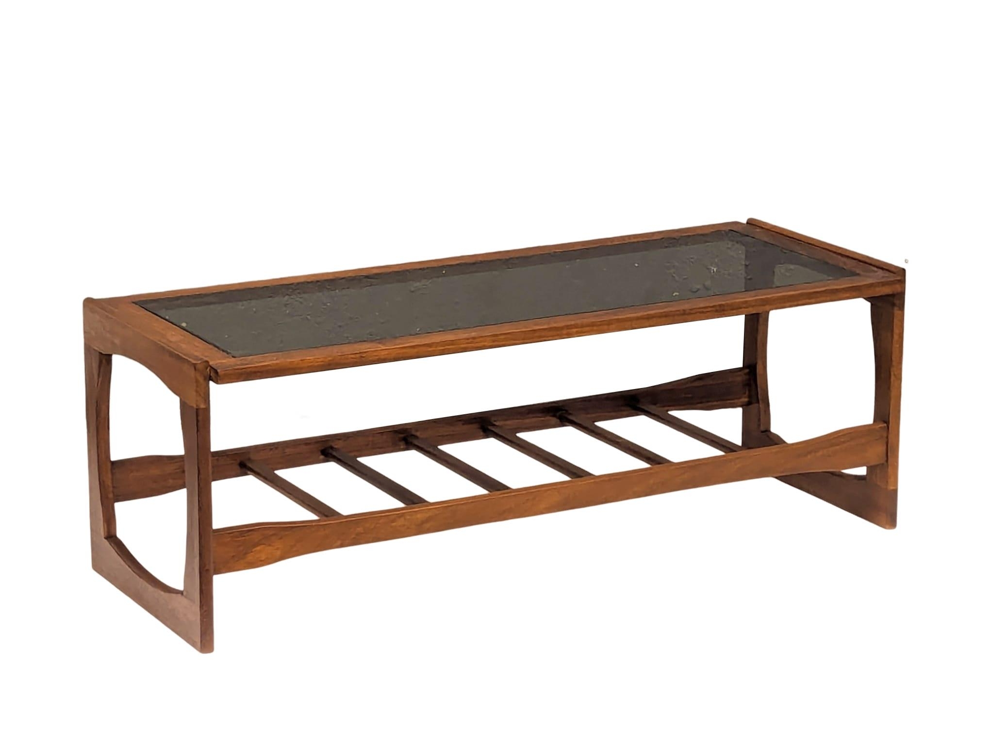 A Mid Century teak and glass top coffee table. 121x47.5x43.5cm