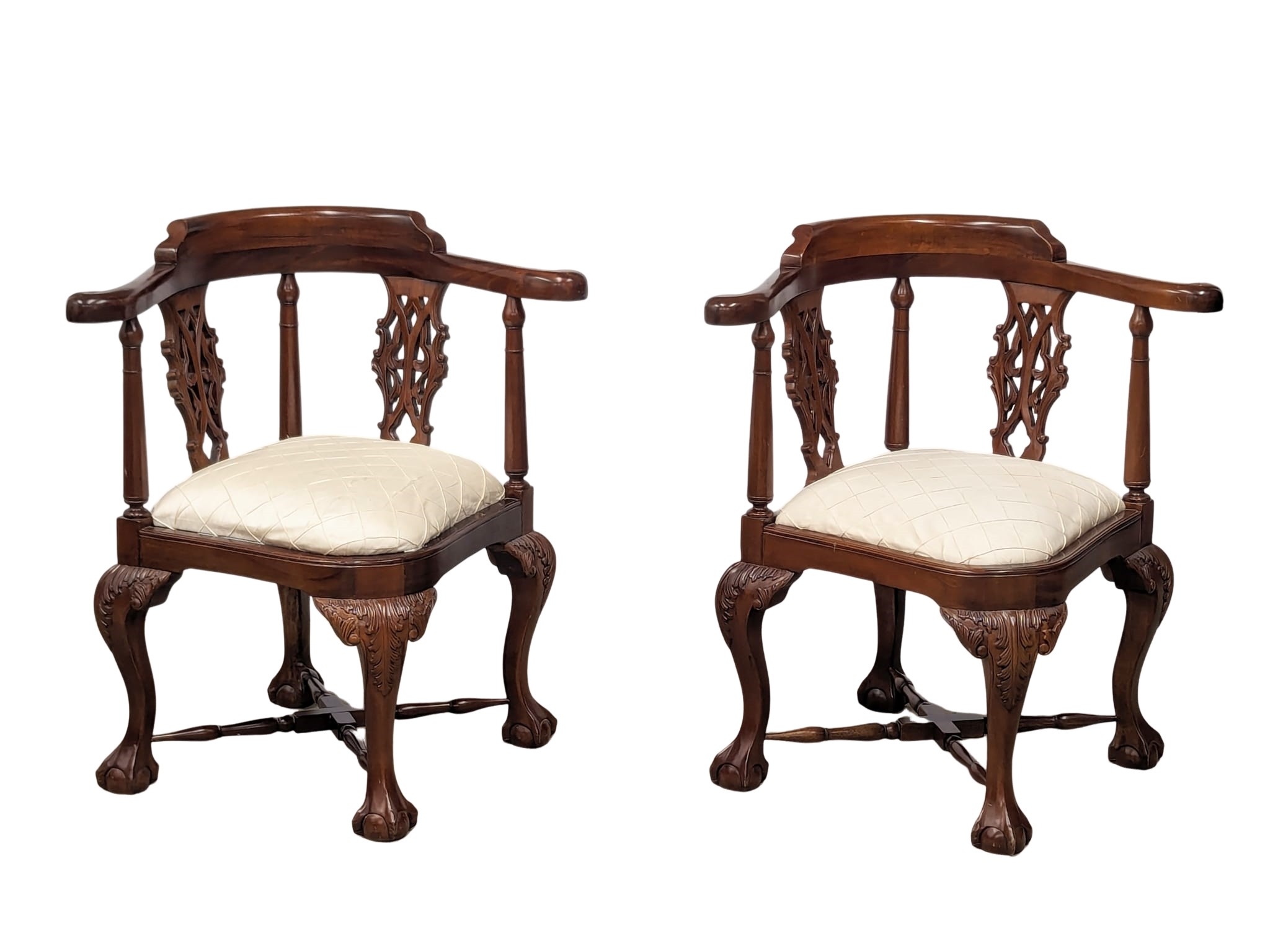 A pair of Chippendale Style mahogany corner armchairs on ball and claw feet.