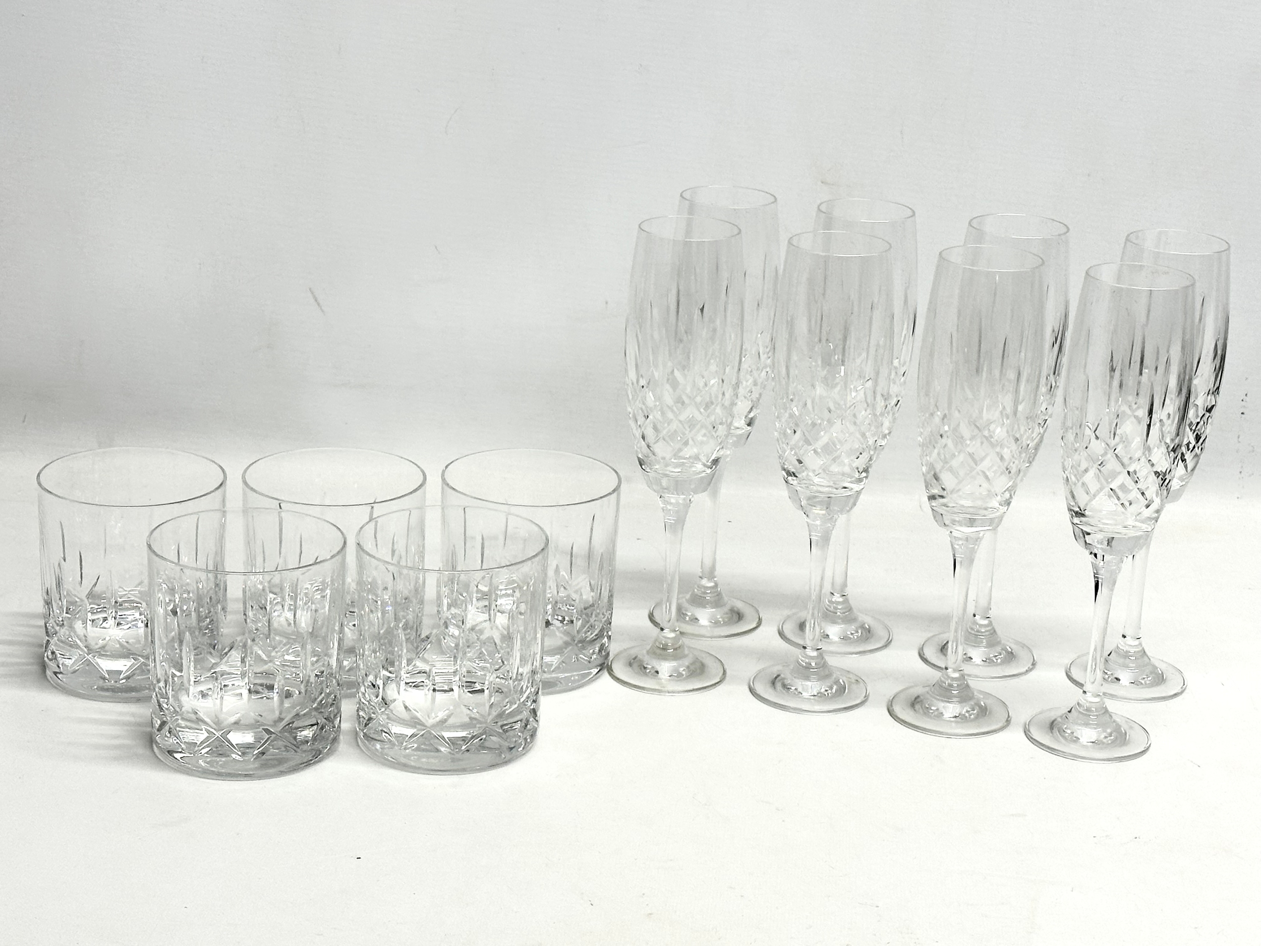 A set of 8 crystal champagne glasses with 5 matching whiskey glasses. 22cm.