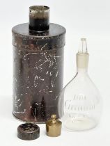 An Early/Mid 19th Century apothecary glass bottle with original tin and weight in lid. 15cm