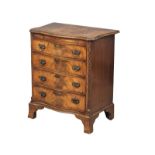 An Early 20th Century Georgian style mahogany serpentine front bachelors chest with brushing slide