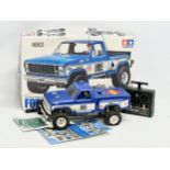 A Tamiya Riko Ford F 150 Ranger XLT radio control pick up truck with box. 1/10 scale. Remote and