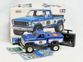 A Tamiya Riko Ford F 150 Ranger XLT radio control pick up truck with box. 1/10 scale. Remote and
