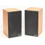 A pair of teak Mission Electronics model 700S speakers.