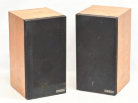 A pair of teak Mission Electronics model 700S speakers.
