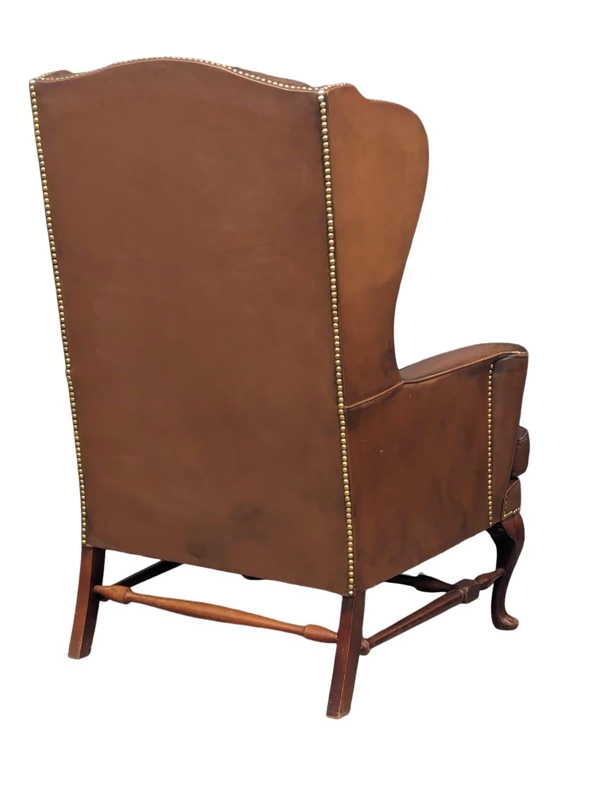 A brown deep button back leather wingback armchair in the early Georgian style - Image 6 of 6