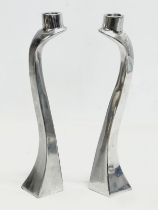 A pair of polished aluminium candlesticks designed by Mathew Hilton. 30cm