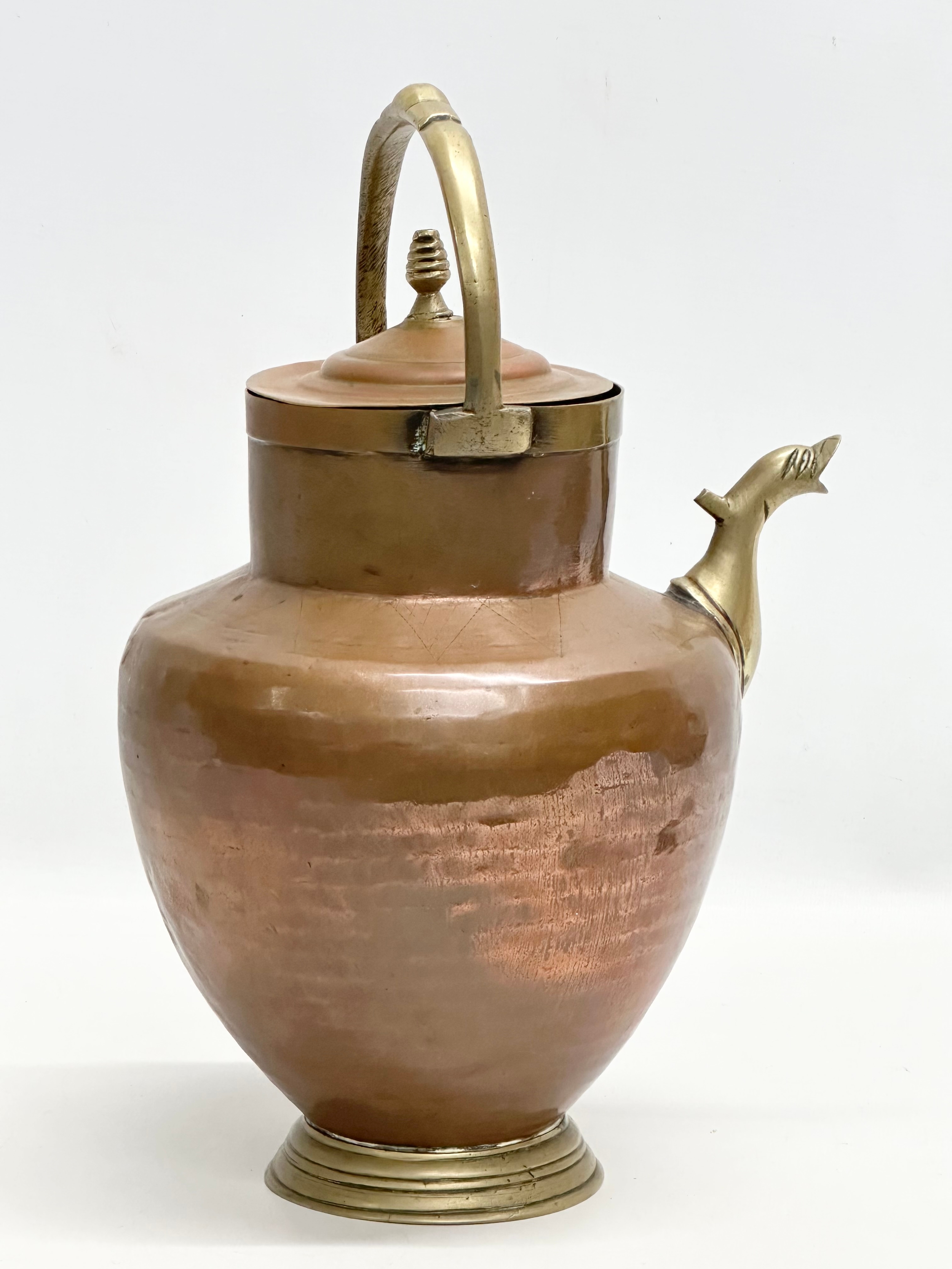 An Early 20th Century Italian copper and brass water pitcher. 22x17x32cm - Image 3 of 3