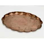 J.F.Pool of Hayle. An Arts & Crafts copper tray with scalloped rim and impressed koi fish design.