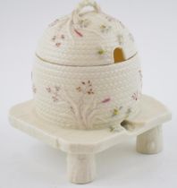 Early Belleek honey pot, of bee skep design, hand painted with bees and grasses, complete with