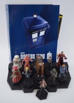 A collection of Doctor Who figures by DW (TM BBC) together with display stand and accompanying