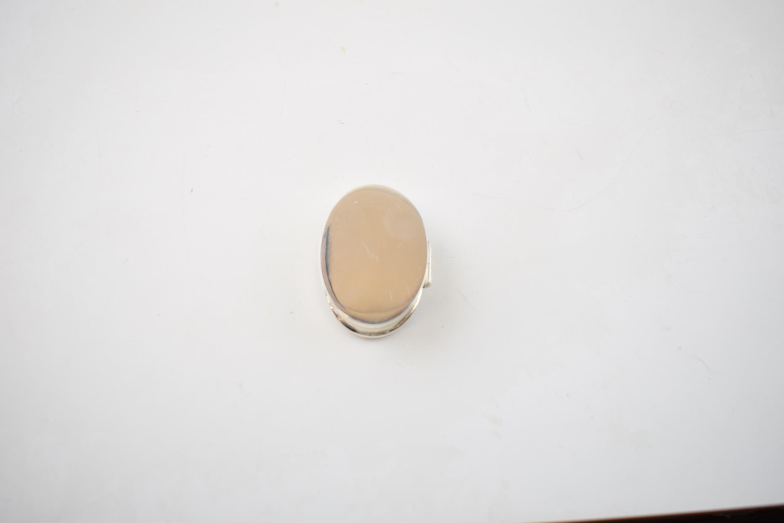 Sterling silver pill box with enamelled insert of a semi-erotic scene, 19.3 grams, 4cm long. - Image 2 of 3