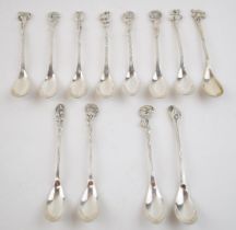 A cased set of continental silver spoons with floral decoration to handles. (12) 130 grams. In