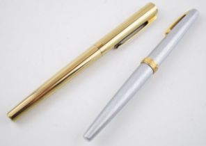 A pair of Sheaffer pens to include a silver example with 14ct gold nib and 1 other (2). Both