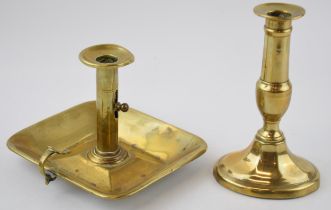 Two 19th century brass candle sticks to include a chamber stick and another similar example.