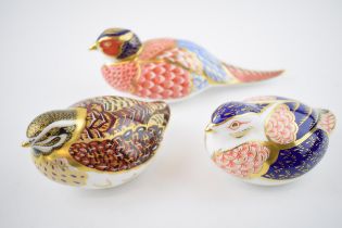 Three Royal Crown Derby paperweights, Pheasant and Dappled Quail, gold stoppers and red Royal